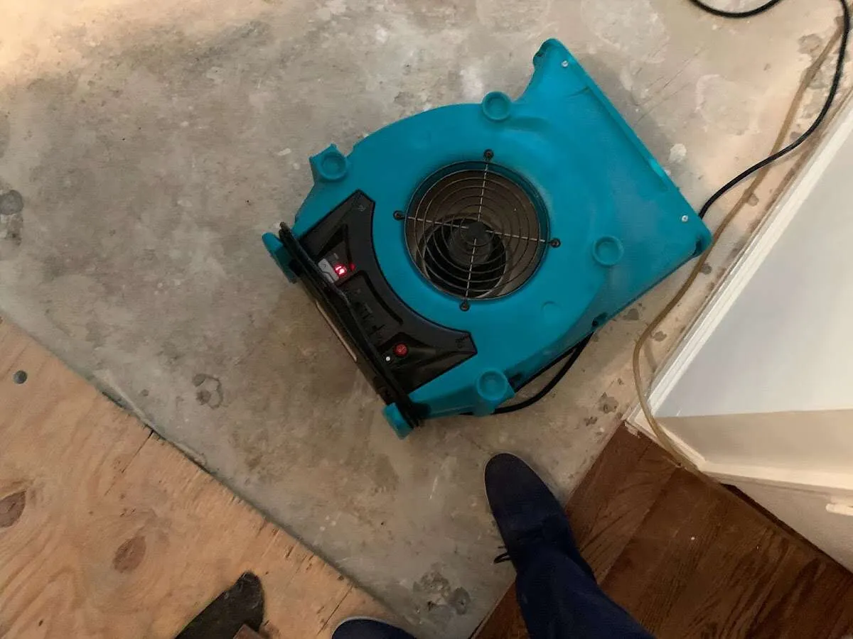 Air mover drying subfloor during Leak Detection & Repair in Manitowoc